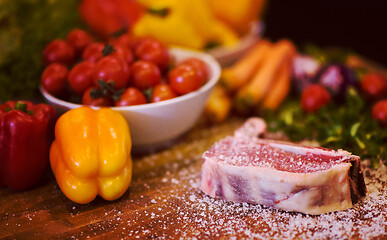 Image showing Juicy slice of raw steak on wooden table