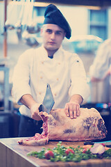 Image showing chef cutting big piece of beef