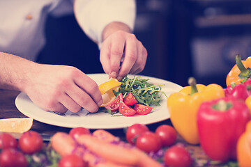 Image showing chef serving vegetable salad