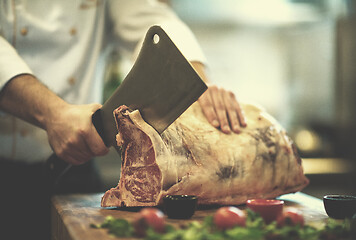 Image showing chef cutting big piece of beef