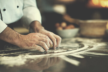 Image showing chef hands preparing dough for pizza