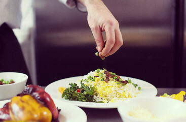 Image showing Chef hands serving vegetable risotto