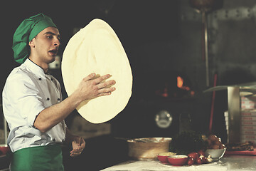 Image showing chef throwing up pizza dough