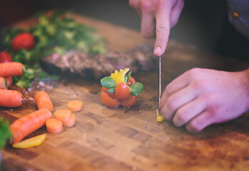 Image showing closeup of Chef hands preparing beef steak