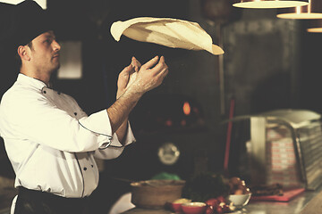 Image showing chef throwing up pizza dough