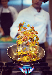 Image showing chef flipping vegetables in wok