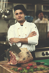 Image showing chef cutting big piece of beef