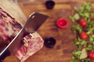 Image showing chef cutting big piece of beef