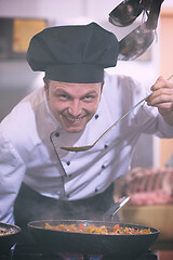 Image showing chef tasting food with spoon