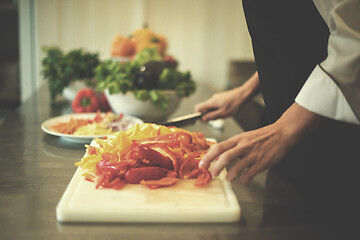 Image showing Chef cutting fresh and delicious vegetables
