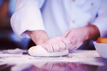 Image showing chef hands preparing dough for pizza