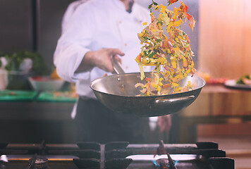 Image showing chef flipping vegetables in wok