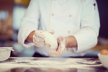 Image showing chef hands preparing dough for pizza