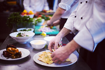 Image showing team cooks and chefs preparing meal