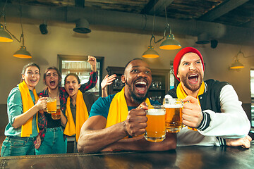 Image showing Sport, people, leisure, friendship and entertainment concept - happy football fans or male friends drinking beer and celebrating victory at bar or pub