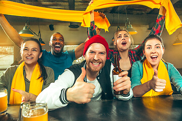 Image showing Sport, people, leisure, friendship and entertainment concept - happy football fans or male friends drinking beer and celebrating victory at bar or pub