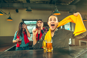 Image showing Sport, people, leisure, friendship and entertainment concept - happy football fans or female friends drinking beer and celebrating victory at bar or pub