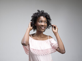 Image showing The happy african woman standing and smiling against red background.