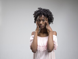 Image showing Woman having headache. Isolated over gray background.