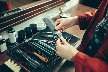 Image showing Female barber in barber shop