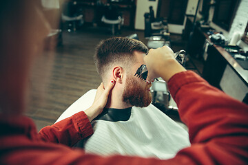 Image showing Client during beard shaving in barber shop