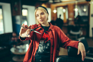 Image showing Female barber in barber shop