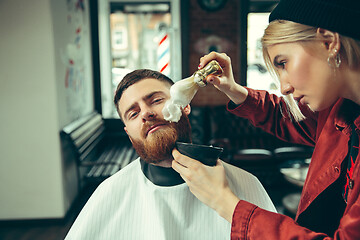 Image showing Client during beard shaving in barber shop