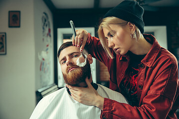 Image showing Client during beard shaving in barber shop