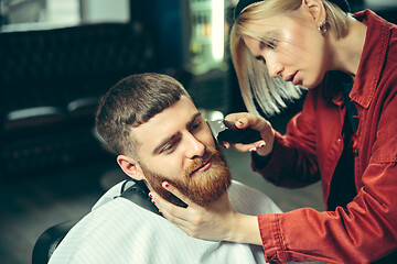 Image showing Client during beard shaving in barber shop