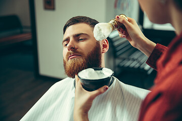 Image showing Client during beard shaving in barber shop