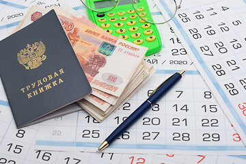 Image showing Labor retirement savings, work book, calendar, pen and glasses on calendar background