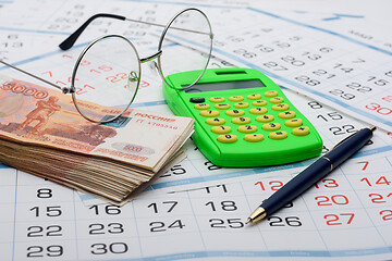 Image showing Concept of savings savings for old age, money, pen, calculator and glasses