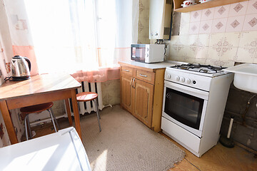 Image showing General view of an old kitchen unit in the interior of a kitchen in need of repair