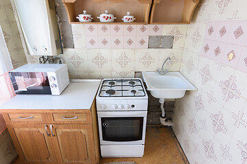 Image showing Old kitchen set in the interior of the kitchen in need of repair