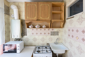 Image showing A fragment of an old kitchen set in the interior of a kitchen in need of repair