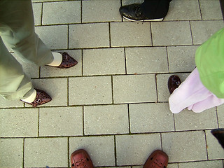 Image showing Feet in shoes on stone floor