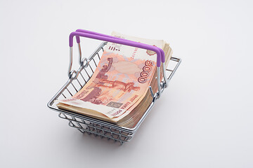 Image showing A large bundle of Russian bills is in a grocery basket, white background