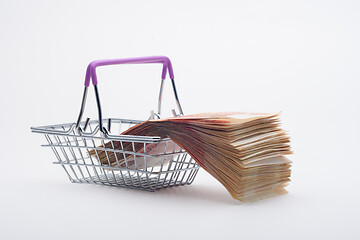 Image showing There is a large stack of bills on a grocery basket, viewed from the side