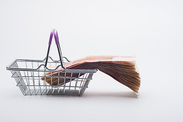 Image showing There is a large stack of bills on the grocery basket