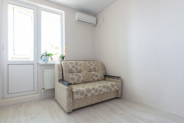 Image showing View of part of the room at the exit to the balcony, sofa and air conditioning