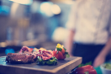 Image showing Juicy slices of grilled steak on wooden board
