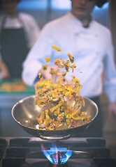 Image showing chef flipping vegetables in wok