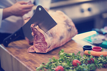 Image showing chef cutting big piece of beef