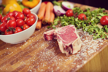 Image showing Juicy slice of raw steak on wooden table