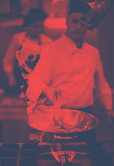 Image showing Chef doing flambe on food