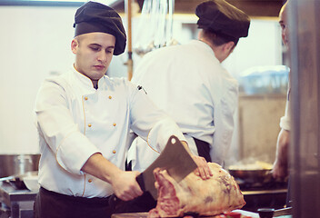 Image showing chef cutting big piece of beef