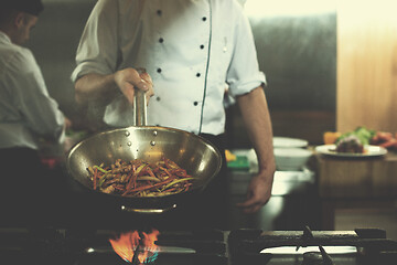 Image showing chef flipping vegetables in wok