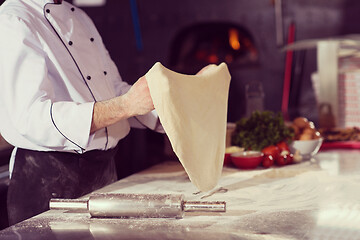 Image showing chef throwing up pizza dough