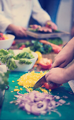 Image showing Chef hands cutting fresh and delicious vegetables