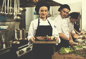 Image showing female Chef holding beef steak plate